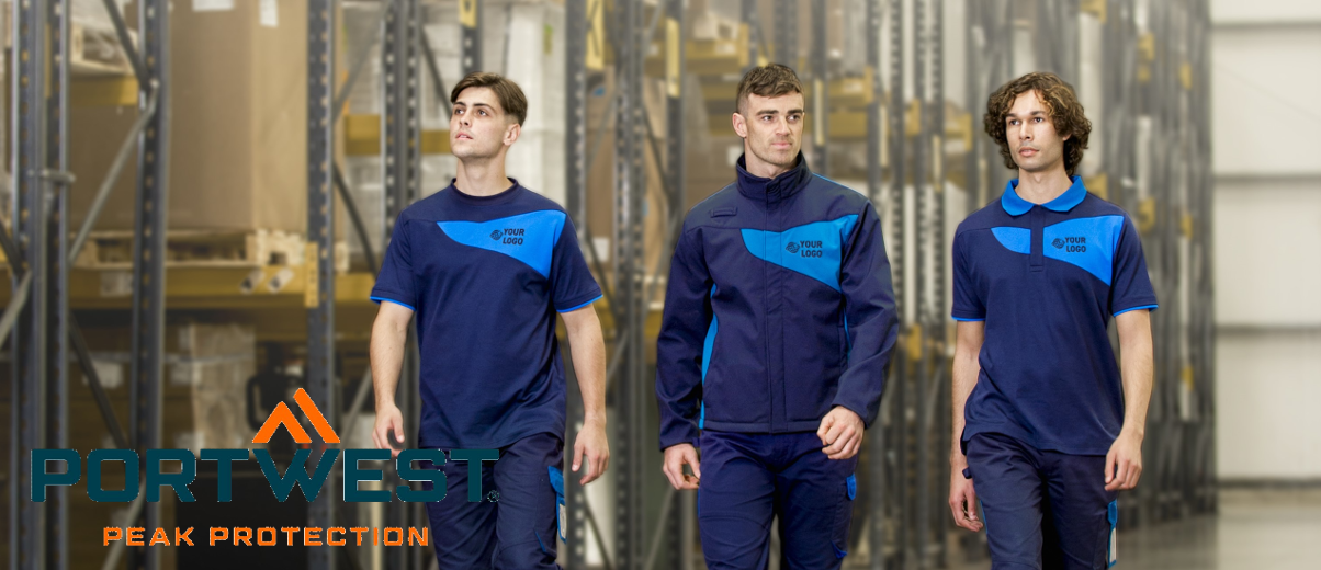 Drei junge Männer in einheitlicher Arbeitskleidung in verschiedenen Blautönen. Im Hintergrund sind Lagerregale zu sehen und im linken unteren Bildbereich findet sich das Logo des Arbeitskleidungsherstellers Portwest.